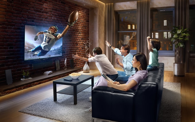 family watching football on a 3d tv
